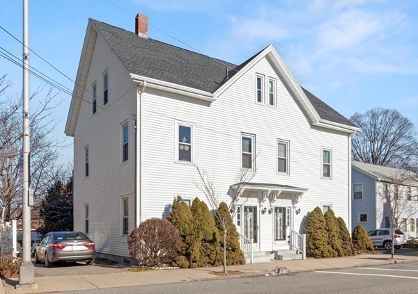38-40 Pleasant Street Reading, MA 01867 - Photo 2 of 25 a front view of a house with a yard