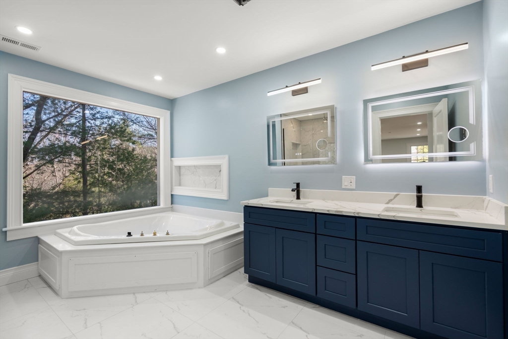 10 Hitching Post Lane Weston, MA 02493 - Photo 30 of 42 a bathroom with a tub a sink and mirror