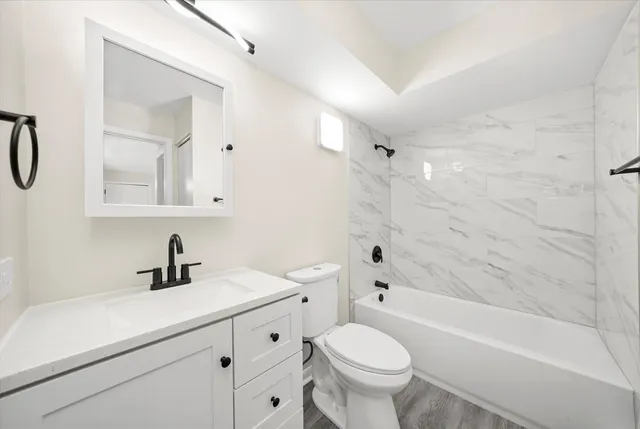 a bathroom with a sink a toilet and a bathtub