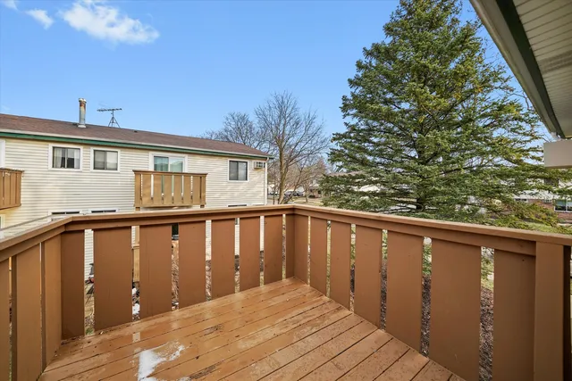 a balcony with wooden floor and fence