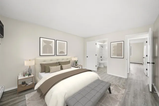 a bedroom with a white bed and white walls