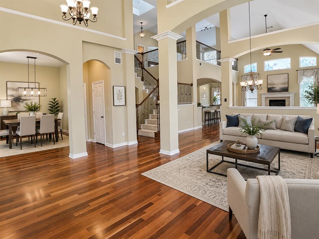 5708 Rickshaw Lane Plano, TX 75094 - Photo 3 of 28 Spacious interior featuring wood-finish flooring, vaulted ceilings, and an arched entryway