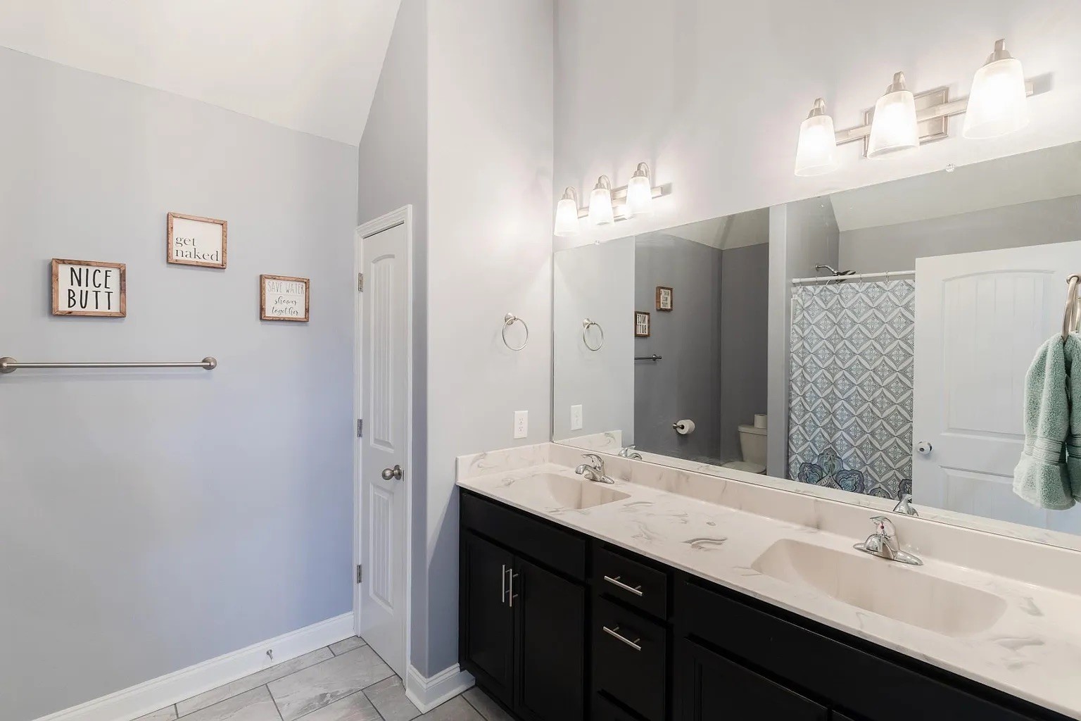 1839 Rains Road Clarksville, TN 37042 - Photo 12 of 22 a bathroom with a double vanity sink a mirror and shower