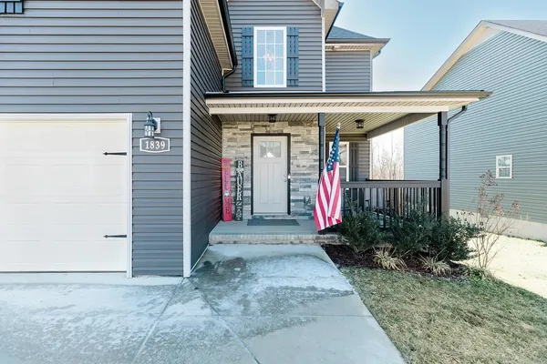 a view of a house with potted plants