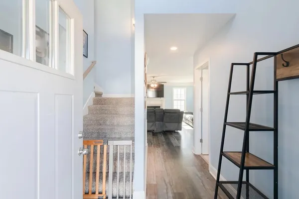 a view of entryway and hall with wooden floor