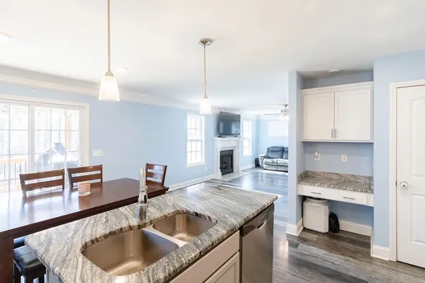 a kitchen with a stove a sink and a wooden floors