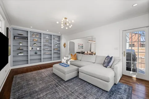a living room with furniture and a chandelier