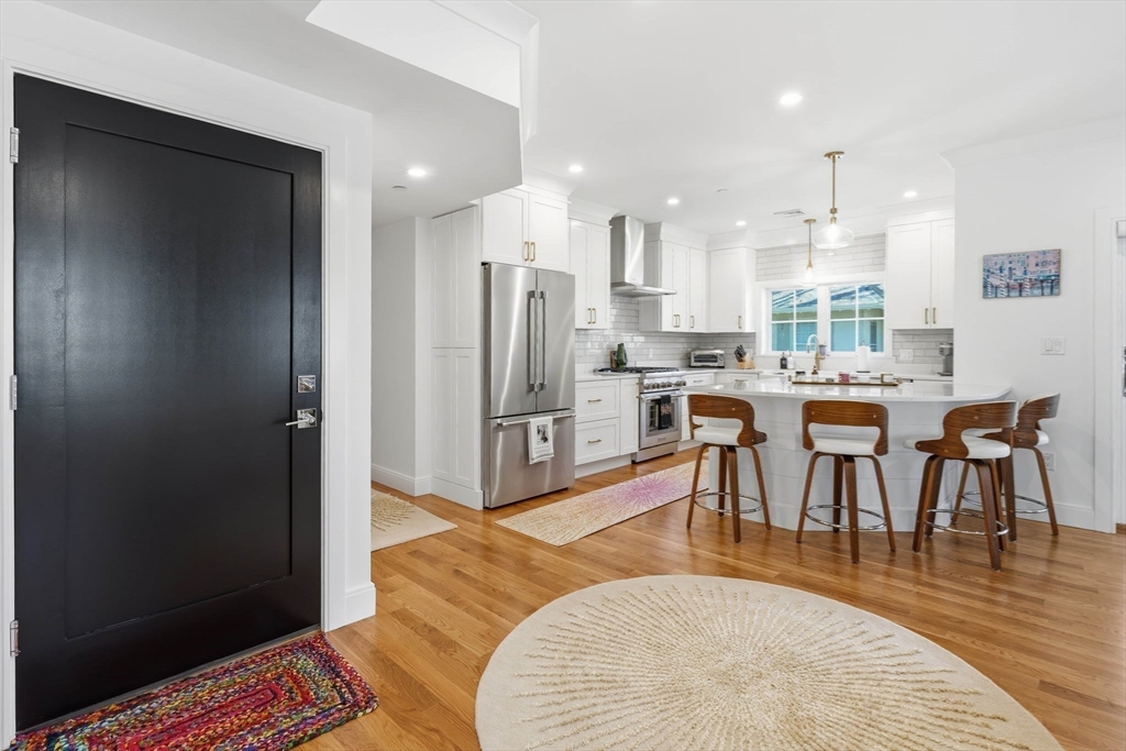 20 Lawrence Street, Unit 2 Wakefield, MA 01880 - Photo 11 of 38 a living room with stainless steel appliances furniture a rug and a view of kitchen