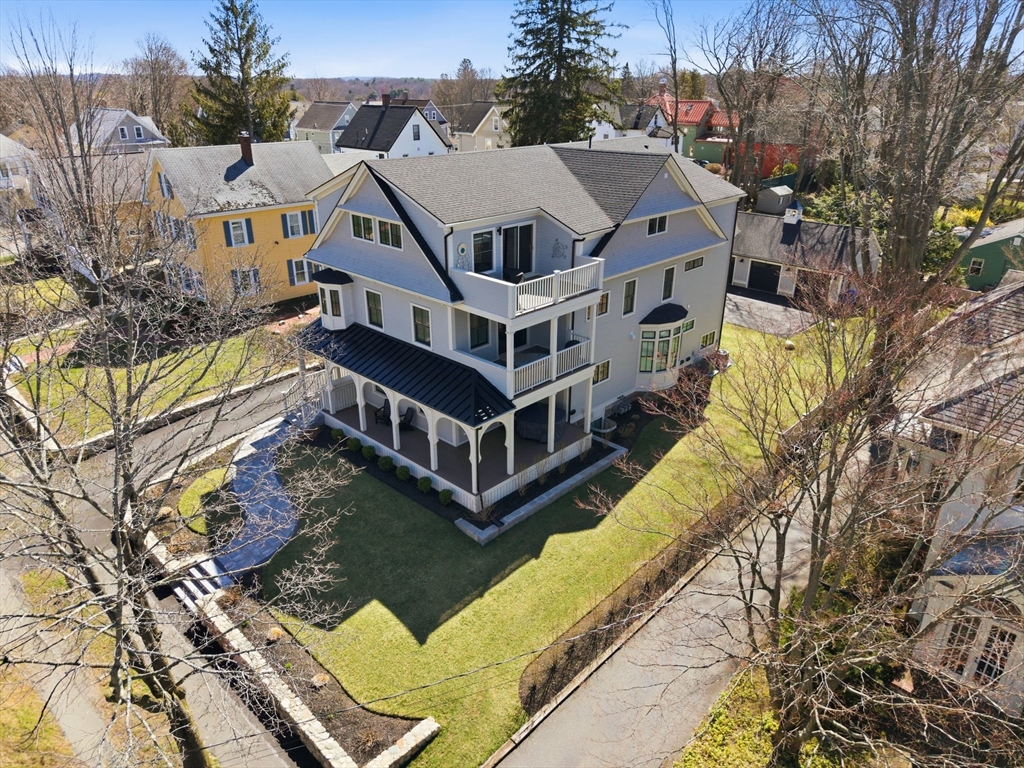 20 Lawrence Street, Unit 2 Wakefield, MA 01880 - Photo 2 of 38 a aerial view of a house with swimming pool and large trees