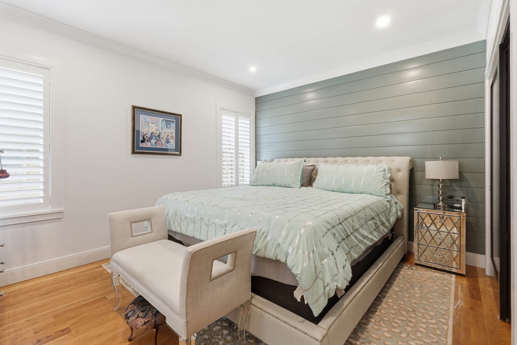 20 Lawrence Street, Unit 2 Wakefield, MA 01880 - Photo 25 of 38 a bedroom with a bed and a night stand
