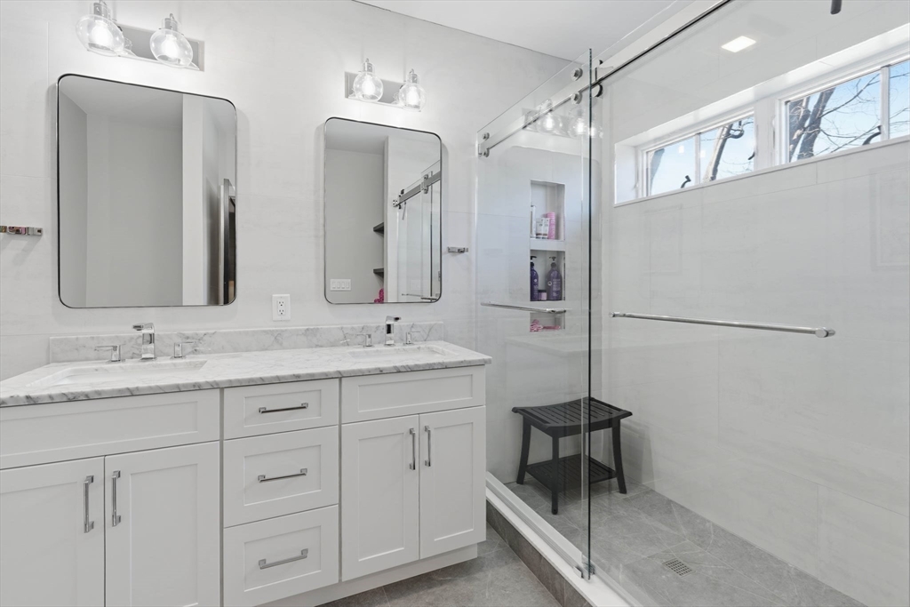 20 Lawrence Street, Unit 2 Wakefield, MA 01880 - Photo 26 of 38 a bathroom with double vanity and a mirror