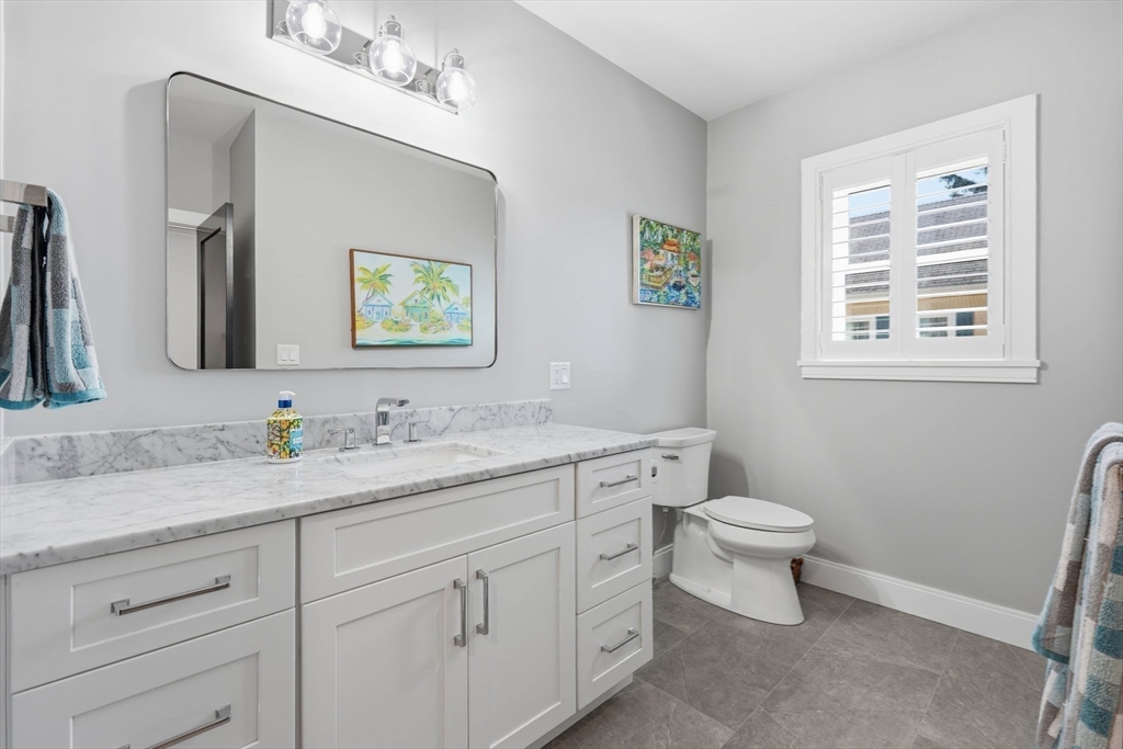 20 Lawrence Street, Unit 2 Wakefield, MA 01880 - Photo 30 of 38 a bathroom with a toilet sink and mirror