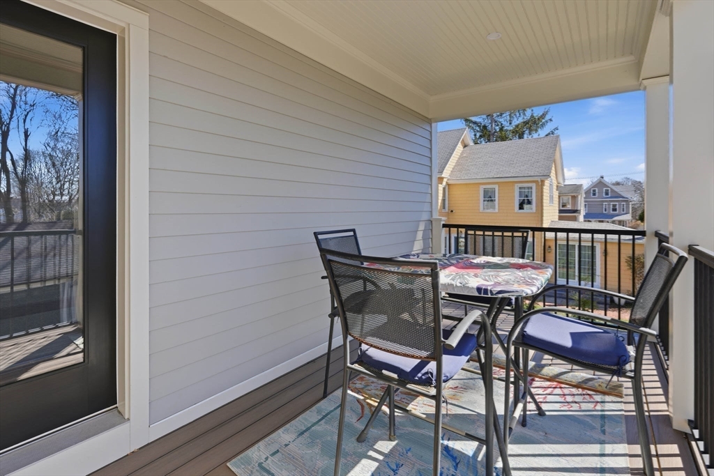 20 Lawrence Street, Unit 2 Wakefield, MA 01880 - Photo 32 of 38 a view of a chairs and table in the balcony