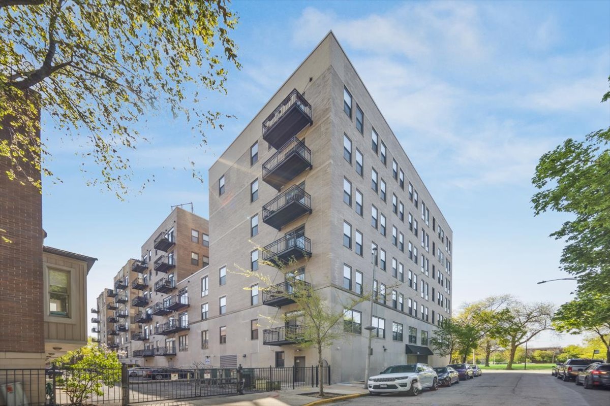 a view of building with yard and staircase