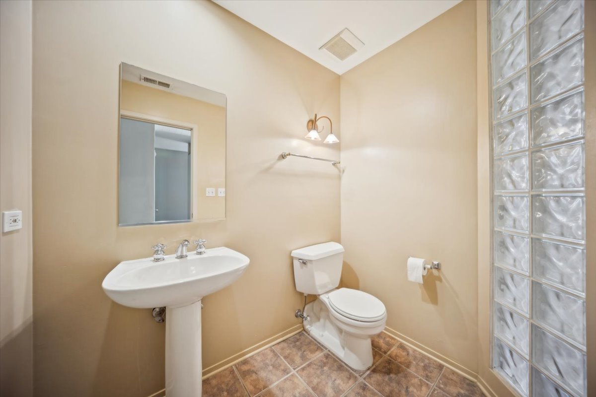 811 South Lytle Street, Unit 101 Chicago, IL 60607 - Photo 12 of 23 a bathroom with a toilet sink and mirror