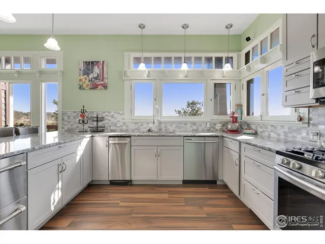 a kitchen with stainless steel appliances granite countertop a sink and cabinets