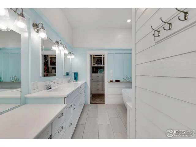 a bathroom with a double vanity sink and mirror