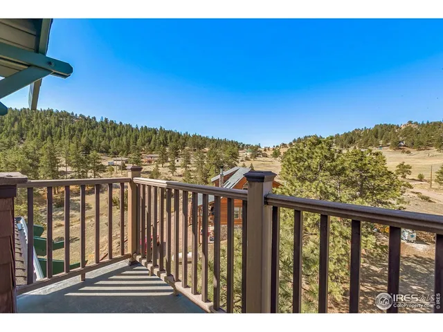 a view of a balcony next to a yard