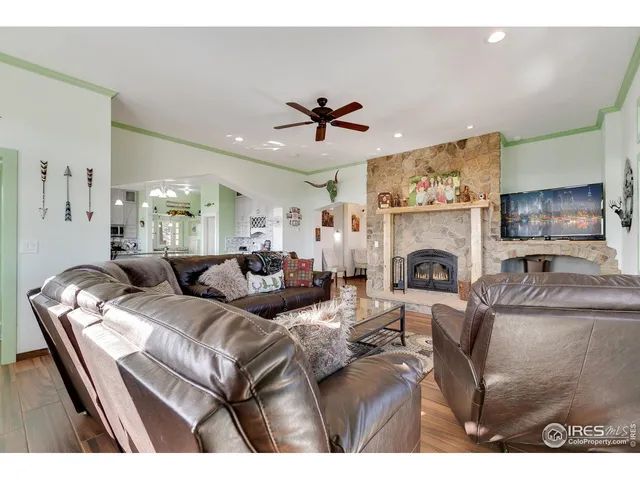 a living room with furniture a fireplace and a chandelier
