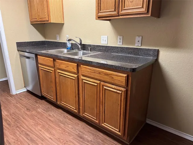 a room with granite countertop a sink and dishwasher