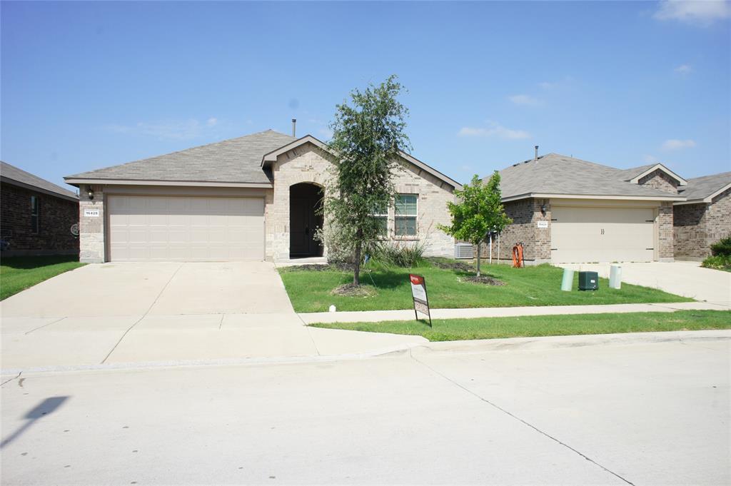 16428 Milwaukee Street Justin, TX 76247 - Photo 14 of 16 a front view of a house with a yard and garage