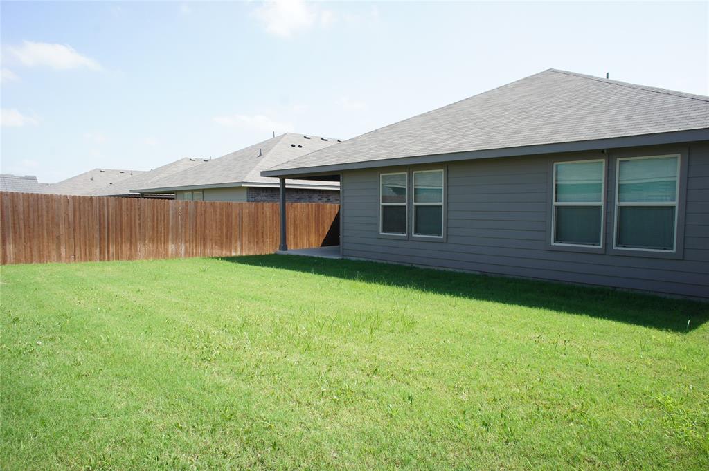 16428 Milwaukee Street Justin, TX 76247 - Photo 16 of 16 a view of a backyard with a garden