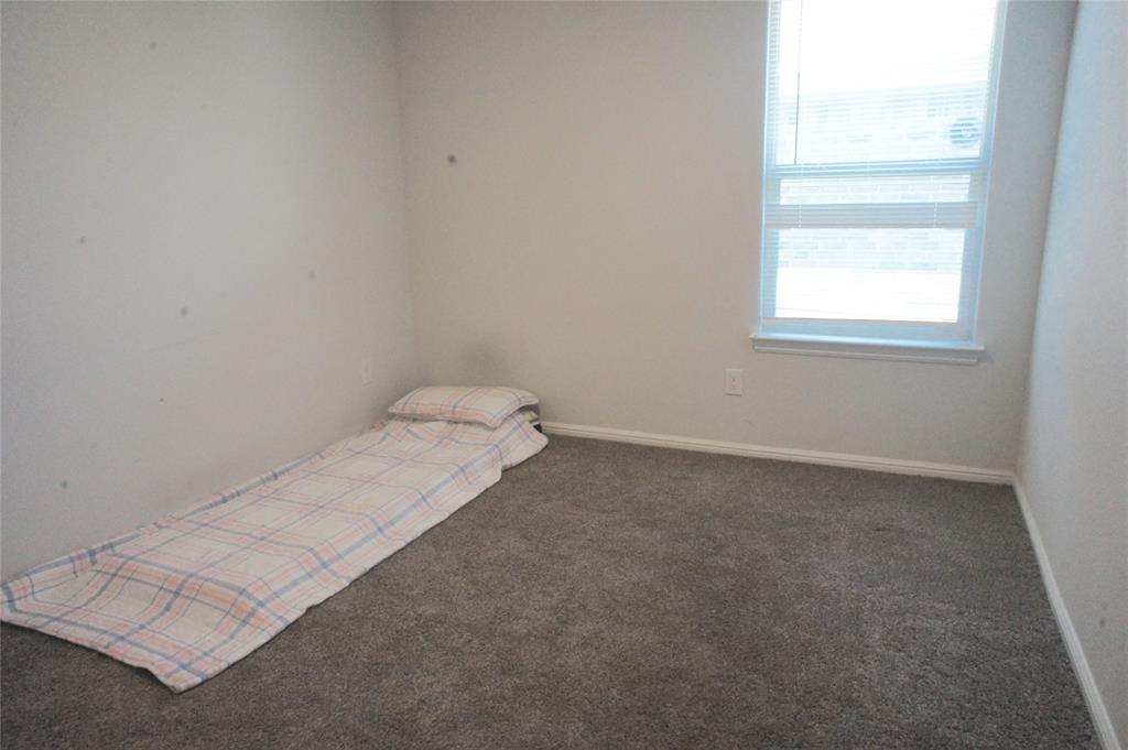 16428 Milwaukee Street Justin, TX 76247 - Photo 4 of 16 an empty room with a window
