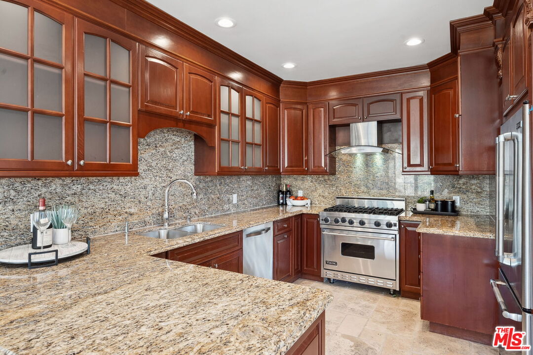 8031 Floral Avenue Los Angeles, CA 90046 - Photo 12 of 34 a kitchen with stainless steel appliances granite countertop a stove a sink and a microwave