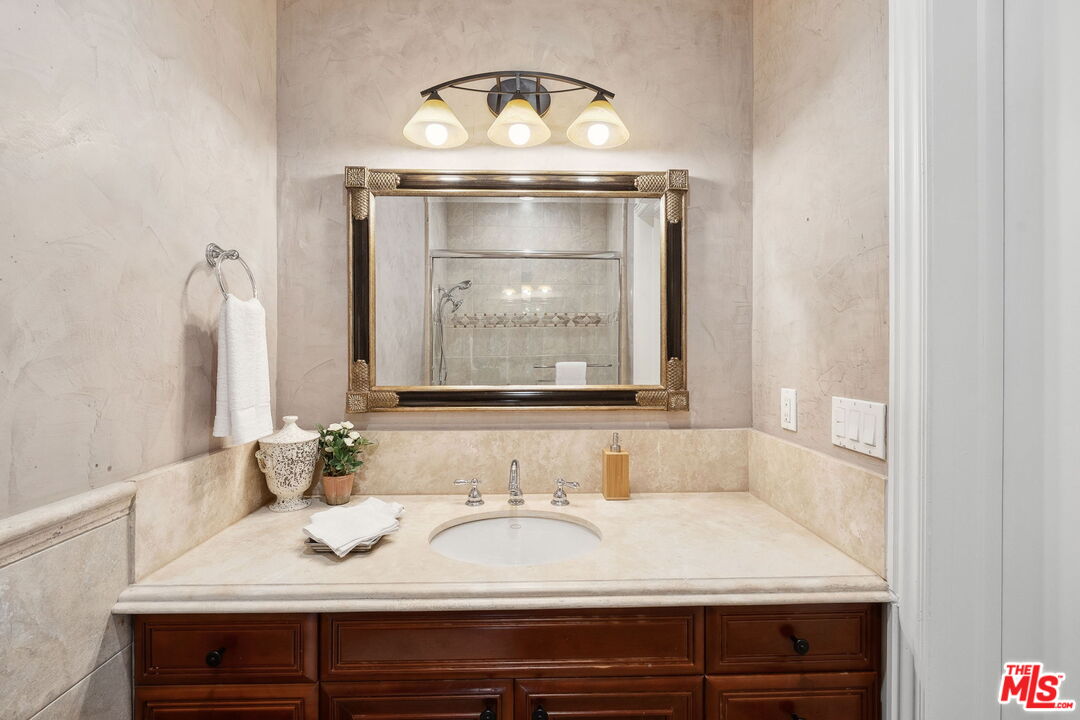 8031 Floral Avenue Los Angeles, CA 90046 - Photo 16 of 34 a bathroom with a sink and a mirror