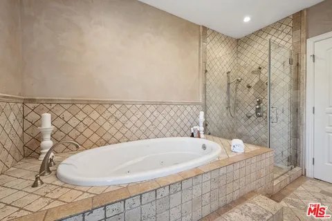 a bathroom with a bathtub and shower