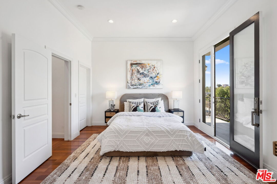 8031 Floral Avenue Los Angeles, CA 90046 - Photo 28 of 34 a bedroom with a bed and wooden floor