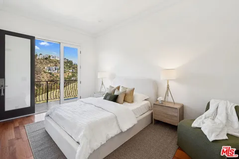 a bedroom with bed and a window