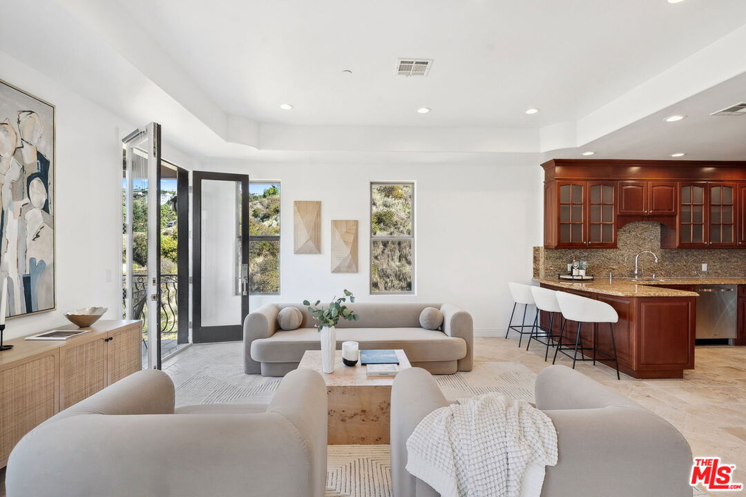 8031 Floral Avenue Los Angeles, CA 90046 - Photo 8 of 34 a living room with furniture and a large window