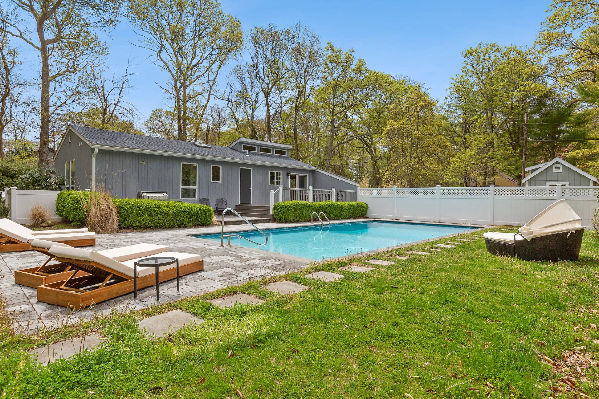 a view of a house with swimming pool and sitting area