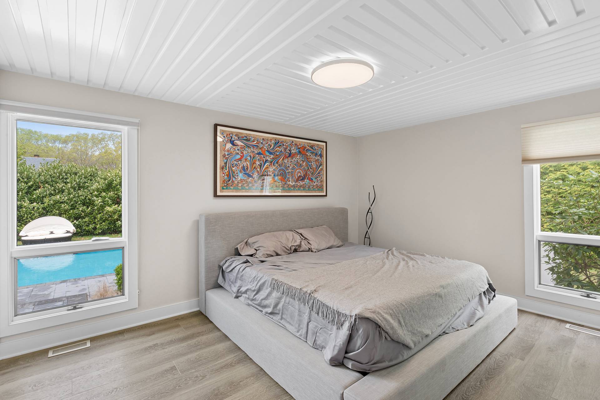 60 Cedar Drive East Hampton, NY 11937 - Photo 7 of 11 a bedroom with a bed painting on wall and a large window