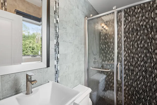 a bathroom with a shower and a sink
