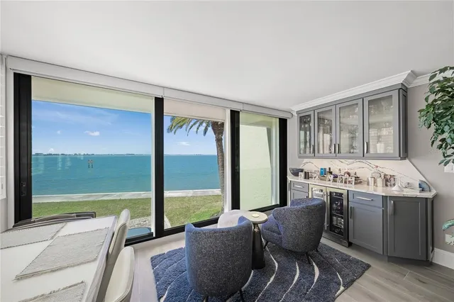 a living room with furniture and a floor to ceiling window