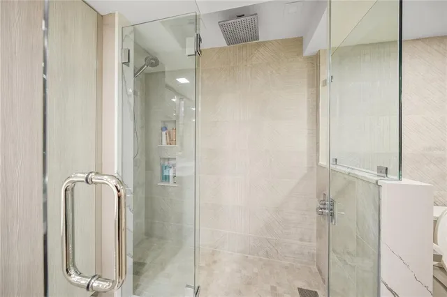 a bathroom with a glass shower door