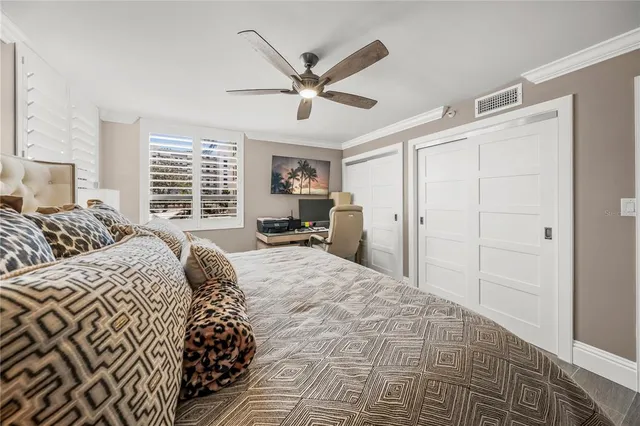 a bedroom with a large bed and a chandelier