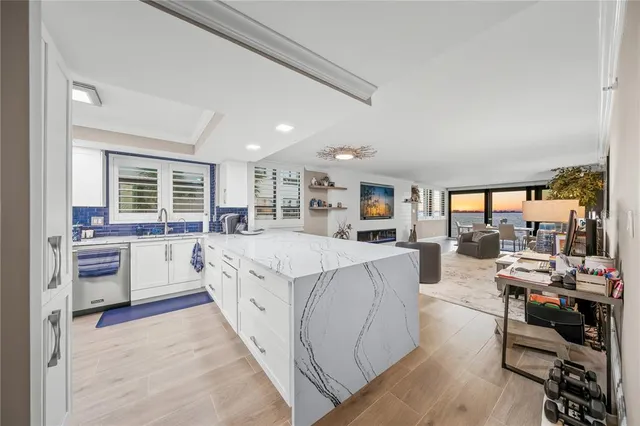 a large white room with a large window and furniture