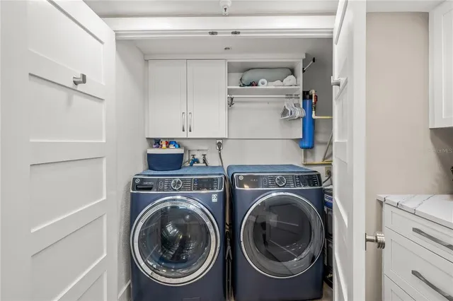 a utility room with sink dryer and washer