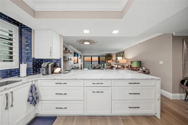 a kitchen with a white cabinets and sink