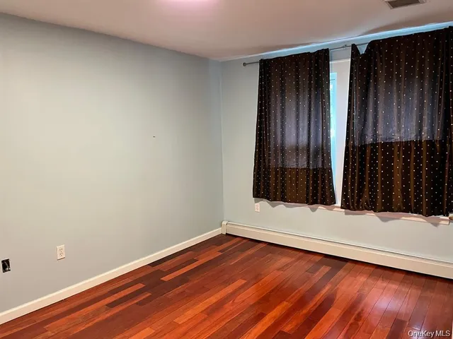 a view of wooden floor and brick walls