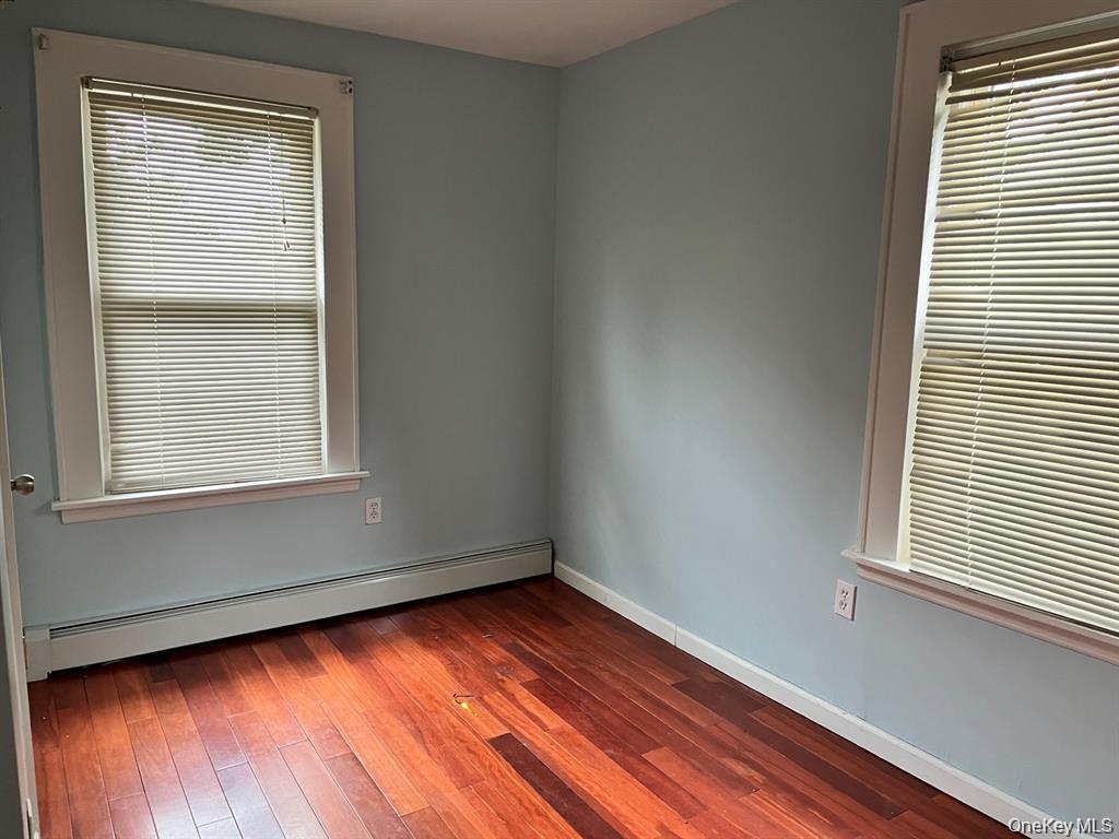 21 Nassau Road Great Neck, NY 11021 - Photo 5 of 9 a view of an empty room with wooden floor and a window
