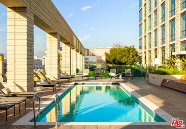 a swimming pool view with a outdoor seating