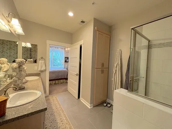 a bedroom with a bed dresser and a window