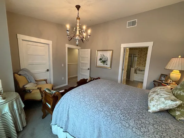 a bathroom with double vanity and a bathtub