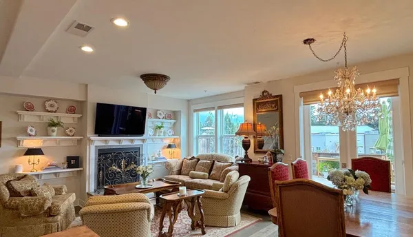 a living room with furniture and a floor to ceiling window
