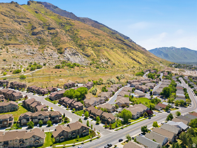 1614 Aspen Loop Provo, UT 84606 - Photo 46 of 47 Residential development with a mountain backdrop, featuring paved roads, mature landscaping, and varied rooflines