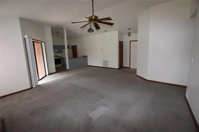 a view of a livingroom with a ceiling fan and window